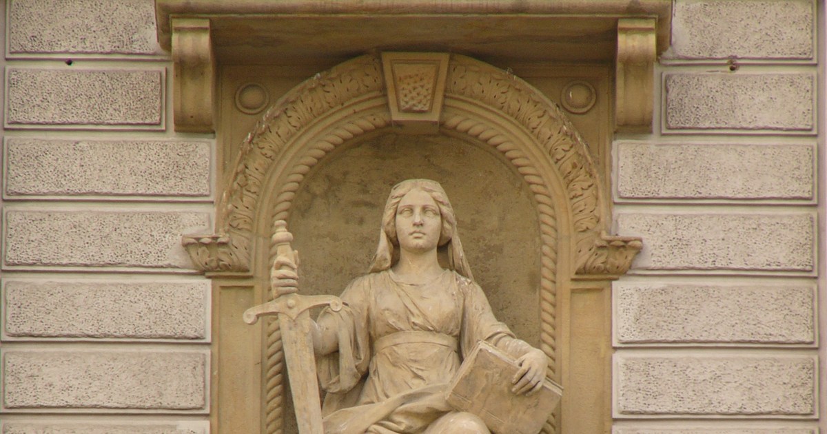 Statue allegorique de la Justice tenant une epee et un livre de loi, symbole de la condamnation penale de Stacie Laughton